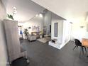 Bright living room boasts soaring ceilings, neutral decor, and tile floors creating a spacious and inviting atmosphere for relaxation at 6533 N 10Th Pl, Phoenix, AZ 85014