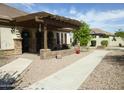 Inviting backyard patio with a charming pergola and desert landscaping at 6687 S Banning St, Gilbert, AZ 85298