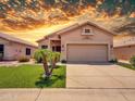 Charming single-story home featuring a well-manicured lawn, desert landscaping, and a two-car garage at 11547 W King Snake Ct, Surprise, AZ 85378