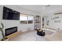 A cozy living room area featuring a decorative fireplace and bright window at 13020 N 18Th St, Phoenix, AZ 85022