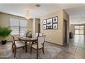Inviting dining room features modern chandelier, wall art, and bright natural light at 13612 W Desert Moon Way, Peoria, AZ 85383