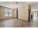Spacious living room with tile flooring, neutral paint, and natural light at 13612 W Desert Moon Way, Peoria, AZ 85383