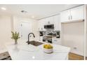 Bright kitchen featuring white cabinets, stainless steel appliances, and marble-look countertops at 1368 W 14Th St, Tempe, AZ 85281