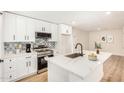 Bright, renovated kitchen with white cabinets, stainless appliances, and designer backsplash at 1368 W 14Th St, Tempe, AZ 85281