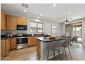 Bright eat-in kitchen features stainless appliances and light wood cabinets at 18391 W Stinson Dr, Surprise, AZ 85374