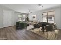 Cozy living room features a ceiling fan, wood floors, and dual windows at 18391 W Stinson Dr, Surprise, AZ 85374