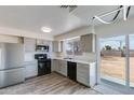Remodeled kitchen features gray cabinets, stainless appliances, quartz countertops and a view to the backyard at 2018 W Western Dr, Chandler, AZ 85224
