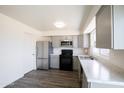 Remodeled kitchen features gray cabinets, stainless appliances, and quartz countertops at 2018 W Western Dr, Chandler, AZ 85224