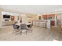 Open floor plan featuring a dining area, living space with a fireplace, and a bar top with stools at 20638 W Main St, Buckeye, AZ 85396