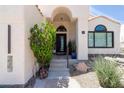 Inviting front entrance with an arched doorway, modern door, and desert-style landscaping at 21 W Cochise Dr, Phoenix, AZ 85021
