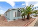 Home exterior showing blue vinyl siding, desert landscaping, shutters and a well-maintained yard at 215 N Power Rd # 33, Mesa, AZ 85205