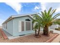 Charming home exterior showcasing blue vinyl siding, desert landscaping and white trim at 215 N Power Rd # 33, Mesa, AZ 85205