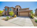 Charming townhome showcasing a two-car garage, desert landscaping, and unique architectural features at 2425 W Bronco Butte Trl # 2028, Phoenix, AZ 85085