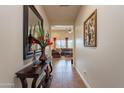 Open hallway leads to a spacious living room, adorned with stylish decor and a view of the backyard at 2599 E San Mateo Dr, Casa Grande, AZ 85194