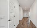 Bright hallway features wood-look tile flooring and white walls at 2640 W Stanton Ave, Apache Junction, AZ 85120