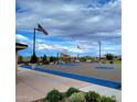 Outdoor community basketball court with American flags, lighting, and seating at 3279 W Molino Rd, San Tan Valley, AZ 85144