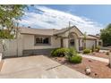 Single-story home with desert landscaping, a two-car garage, and an inviting entryway at 3307 E Roveen Ave, Phoenix, AZ 85032