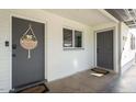 Inviting front entrance featuring a welcome sign, gray doors, and clean white brickwork at 3330 E Cypress St, Phoenix, AZ 85008