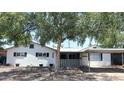 Charming single-story home with a covered front porch and mature landscaping providing ample shade at 3330 E Cypress St, Phoenix, AZ 85008