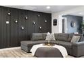 Comfortable living room with modern decor, a large gray sectional, and stylish accent wall at 3330 E Cypress St, Phoenix, AZ 85008