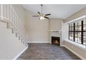 A bright room features a fireplace, tile floor, and large windows which adds architectural details to the living space at 3491 N Arizona Ave # 174, Chandler, AZ 85225