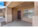 Covered front entryway leading to a dark wood door and sidelight window at 36265 W Alhambra St, Maricopa, AZ 85138