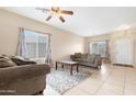 Bright living room featuring tile floors, neutral walls, and comfortable seating at 36265 W Alhambra St, Maricopa, AZ 85138