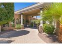 Beautiful stone-paved driveway leading to a covered entrance, complemented by lush greenery and refined stonework at 3731 E Halifax Cir, Mesa, AZ 85205