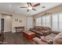 Inviting living room featuring a ceiling fan, comfortable sofa, and lots of natural light at 40089 W Bonneau St, Maricopa, AZ 85138