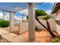 Covered walkway featuring wooden slats, neutral posts, and desert landscaping at 4024 W Griswold Rd, Phoenix, AZ 85051