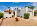 Charming home featuring a well-maintained gravel yard and a covered entrance under a partly cloudy sky at 4024 W Griswold Rd, Phoenix, AZ 85051