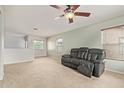 Bright loft space with carpet flooring, a ceiling fan, neutral walls, and lots of natural light at 41158 W Cahill Dr, Maricopa, AZ 85138
