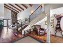 Spacious living area with wood floors, beamed ceilings, and a fireplace with stone surround at 4242 N 44Th St, Phoenix, AZ 85018