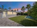 Private backyard with artificial turf, pool, patio, lemon tree, and palm trees at 4320 N 35Th St, Phoenix, AZ 85018