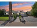 Charming single-story home featuring a well-manicured lawn and a brick driveway leading to an attached garage at 4320 N 35Th St, Phoenix, AZ 85018