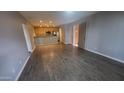 A spacious living room with hardwood floors extends into the kitchen with stainless steel appliances at 4704 E Paradise Village N Pkwy # 211, Phoenix, AZ 85032