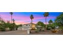 Majestic home featuring a well-manicured front yard, mature trees, and a beautiful desert landscape at 4824 E Hummingbird Ln, Paradise Valley, AZ 85253