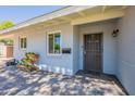 Inviting front entrance with a charming patio, decorative planters, and a secure screen door at 6121 N 11Th St, Phoenix, AZ 85014