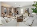 Spacious living room with stylish furniture, opening to the modern kitchen and dining area at 6623 E Marisa Ln, Phoenix, AZ 85054