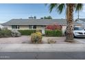 Cozy home showcasing vibrant flowers and manicured shrubs along the front yard landscape at 7255 E Coronado Rd, Scottsdale, AZ 85257