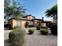 Attractive home featuring stone accents, desert landscaping, and an attached garage at 7751 E Golden Eagle Cir, Gold Canyon, AZ 85118