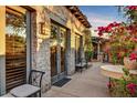 Enchanting outdoor patio with stone wall, bougainvillea and plenty of light creating the perfect outdoor space at 7751 E Golden Eagle Cir, Gold Canyon, AZ 85118