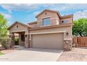 Charming two-story home featuring stone accents, a spacious two-car garage, and beautiful desert landscaping at 7812 S 67Th Ln, Laveen, AZ 85339