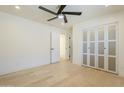 Spacious bedroom featuring hardwood floors, modern ceiling fan, closet, and white walls to create a bright and airy feel at 8525 E Vía De Los Libros --, Scottsdale, AZ 85258