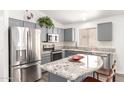 Bright kitchen with granite countertops, stainless steel appliances, gray cabinets and a kitchen island at 8648 W Fargo Dr, Peoria, AZ 85382