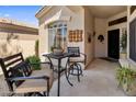 Inviting front patio with outdoor seating area, tiled floor, and decorative wall art at 8934 E Calle Buena Vis, Scottsdale, AZ 85255