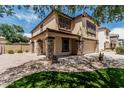 Beautiful two-story home with manicured lawn and desert landscape in front yard at 10440 E Osage Ave, Mesa, AZ 85212