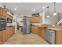 Bright kitchen with stainless steel appliances, wood cabinets, and an open layout at 10613 E Knowles Ave, Mesa, AZ 85209