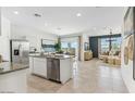 Bright, open kitchen with a center island, stainless steel appliances, and a seamless flow to the living space at 11858 E Cliffrose Ln, Florence, AZ 85132