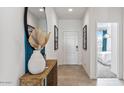 Inviting foyer with a decorative table, mirror, and view into a bedroom, offering a warm welcome to the home at 12247 E Agave Ln, Florence, AZ 85132